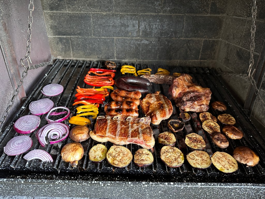 This is a photo of meat and veggies on a parrilla, or grill, a very standard tradition in Argentina.
