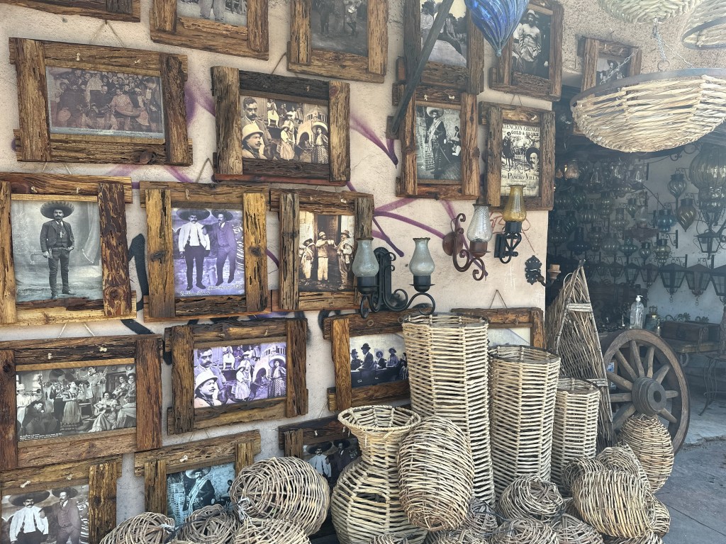 Old photos on a wall with wicker baskets in front