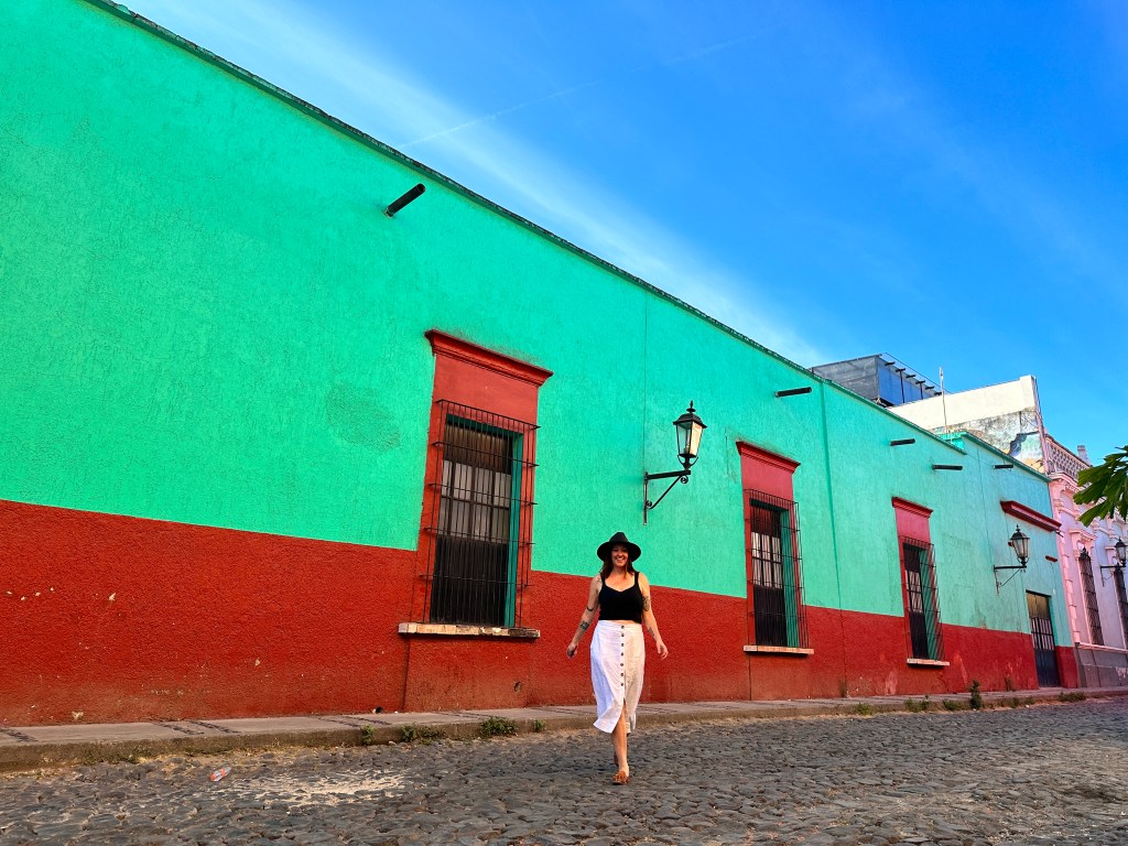 Nicki walks on the empty cobblestone streets of Tequila. Tequila is a good day trip from Guadalajara.