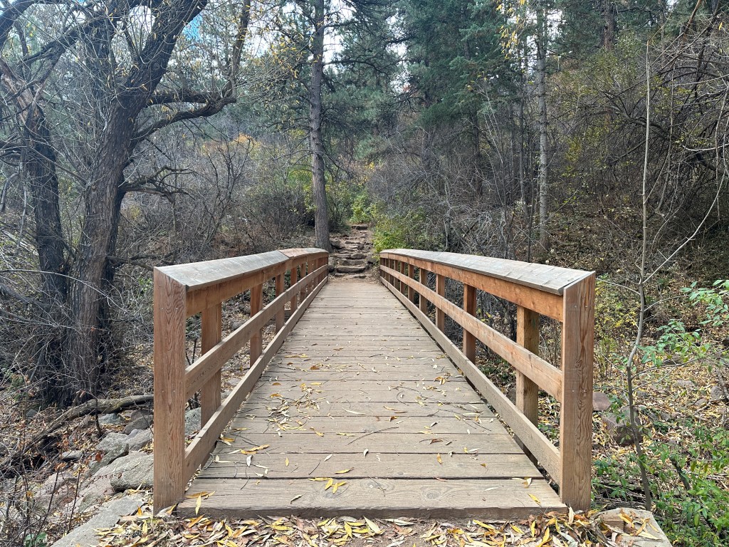 This is a picture of a bridge. If you cross the bridge, you will find the Amphitheater Trail.