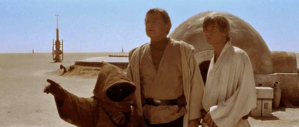 Luke Skywalker and his uncle Owen speak to a Jawas in front of the Lars Homestead while bargaining to purchase droids.