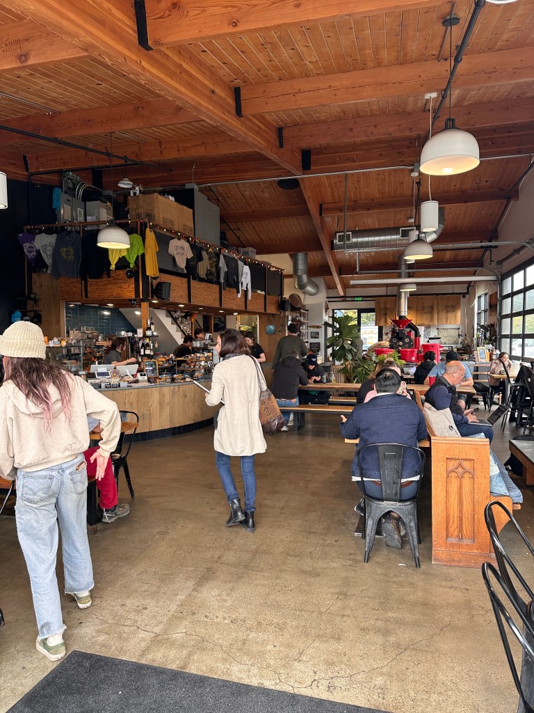 Soul Grind is one of the most popular coffee shops in Pacifica for good reason. This is the interior of the cafe with many people.
